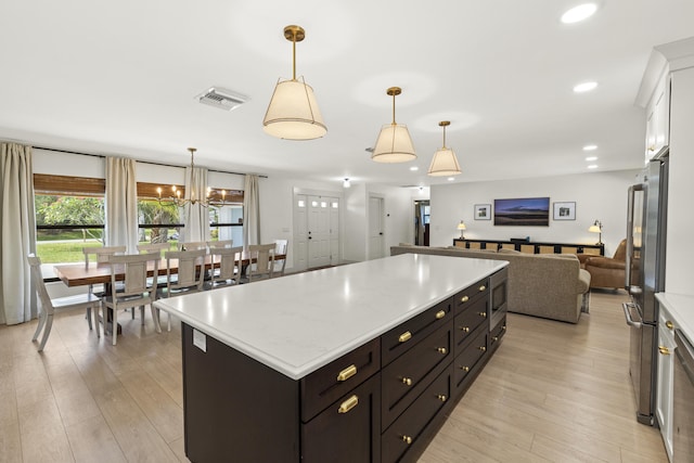 4972 S Kay St, Palm Beach Gardens, FL 33418 - kitchen with open floor plan, light countertops, appliances with stainless steel finishes, light wood-style flooring, and recessed lighting