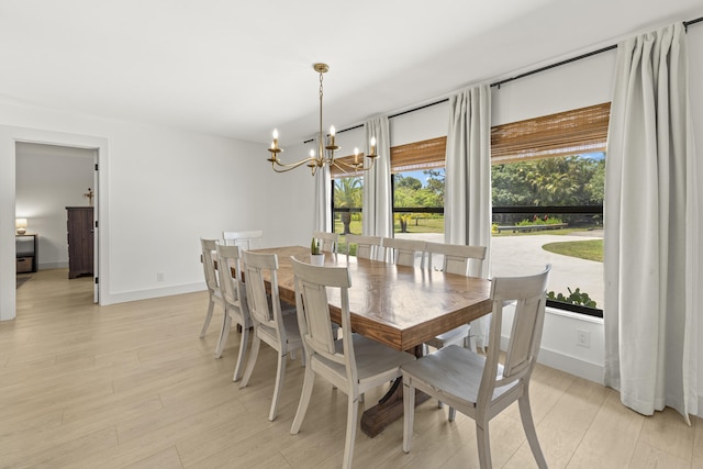 4972 S Kay St, Palm Beach Gardens, FL 33418 - dining space featuring a chandelier, light wood-style floors, and baseboards