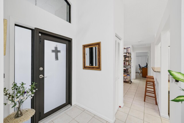 703 Sea Oats Dr Unit A-5, Juno Beach, FL 33408 - foyer entrance featuring light tile patterned flooring and baseboards