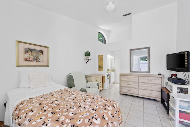 703 Sea Oats Dr Unit A-5, Juno Beach, FL 33408 - bedroom with light tile patterned floors, a towering ceiling, and connected bathroom