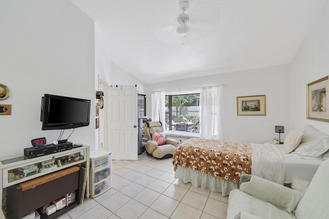 703 Sea Oats Dr Unit A-5, Juno Beach, FL 33408 - bedroom featuring vaulted ceiling, light tile patterned floors, and a textured ceiling