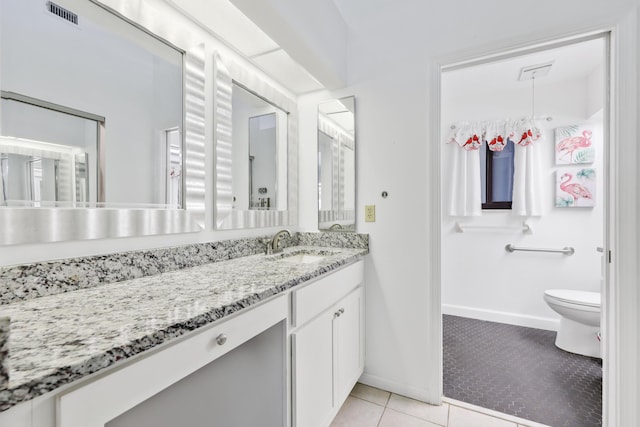 703 Sea Oats Dr Unit A-5, Juno Beach, FL 33408 - bathroom featuring tile patterned floors, vanity, baseboards, and toilet