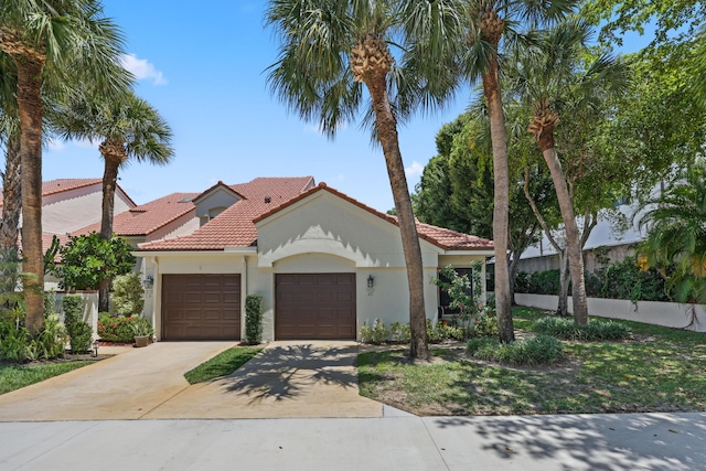 703 Sea Oats Dr Unit A-5, Juno Beach, FL 33408 - mediterranean / spanish house featuring an attached garage, a tiled roof, driveway, and stucco siding