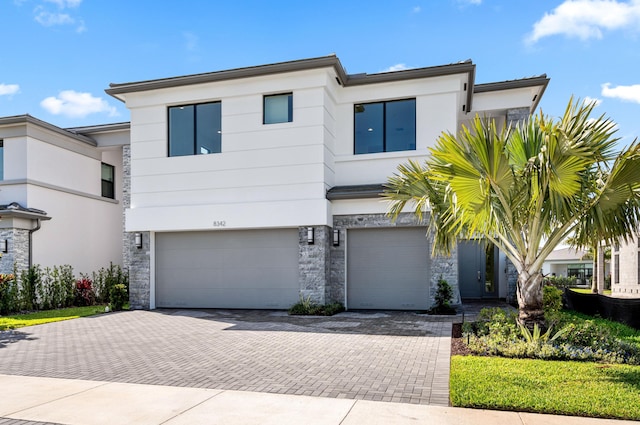 8342 Crystal Downs Ave, Boca Raton, FL 33434 - contemporary home featuring stone siding, decorative driveway, a garage, and stucco siding