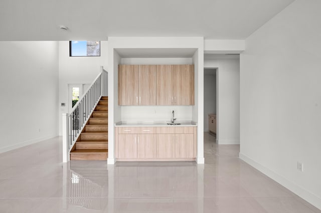 8342 Crystal Downs Ave, Boca Raton, FL 33434 - kitchen featuring light brown cabinetry, modern cabinets, light countertops, baseboards, and a sink