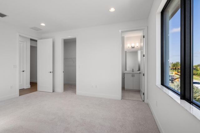 8342 Crystal Downs Ave, Boca Raton, FL 33434 - unfurnished bedroom with light colored carpet, recessed lighting, a walk in closet, baseboards, and connected bathroom