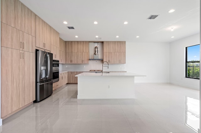 8342 Crystal Downs Ave, Boca Raton, FL 33434 - kitchen with modern cabinets, light brown cabinetry, stainless steel appliances, light countertops, and a kitchen island with sink