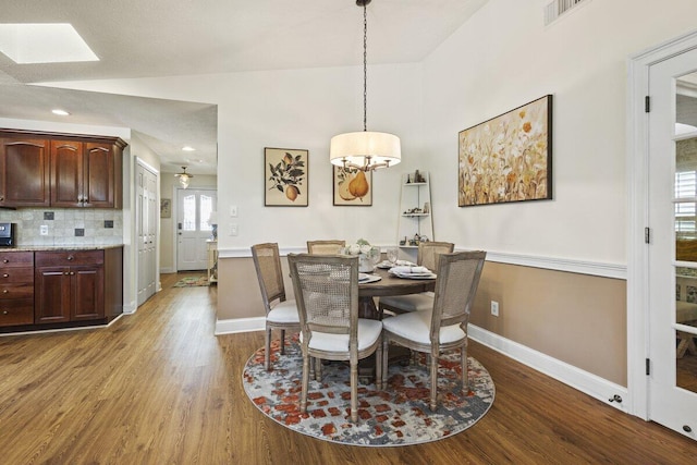 1345 SW Cedar Cv E, Port Saint Lucie, FL 34986 - dining room with dark wood-style flooring, baseboards, a skylight, and recessed lighting