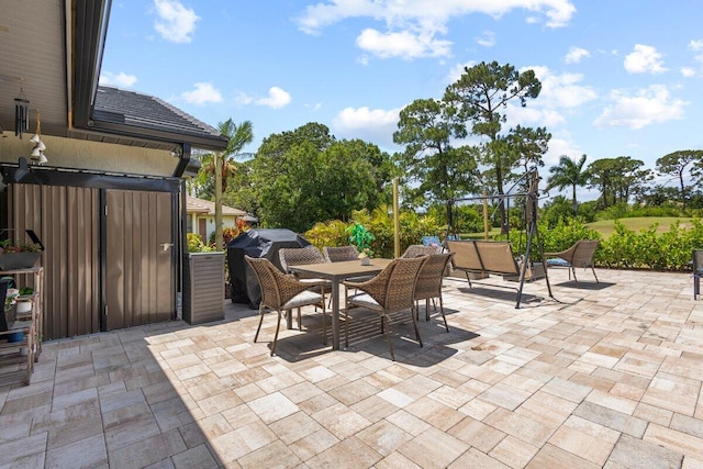 1345 SW Cedar Cv E, Port Saint Lucie, FL 34986 - view of patio with outdoor dining space and a grill