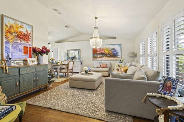 1345 SW Cedar Cv E, Port Saint Lucie, FL 34986 - living room with dark wood finished floors, a chandelier, and vaulted ceiling