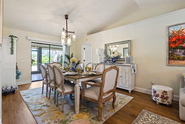 1345 SW Cedar Cv E, Port Saint Lucie, FL 34986 - dining area featuring a chandelier, vaulted ceiling, wood finished floors, and baseboards