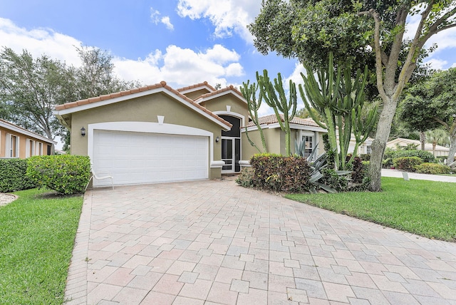 12092 Aprilia Dr, Boynton Beach, FL 33437 - view of front facade with stucco siding, decorative driveway, a front yard, a tiled roof, and a garage
