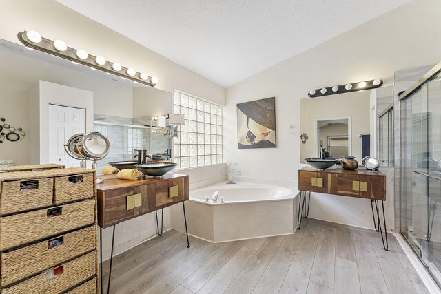 12092 Aprilia Dr, Boynton Beach, FL 33437 - full bathroom featuring a shower stall, a garden tub, wood finished floors, and lofted ceiling
