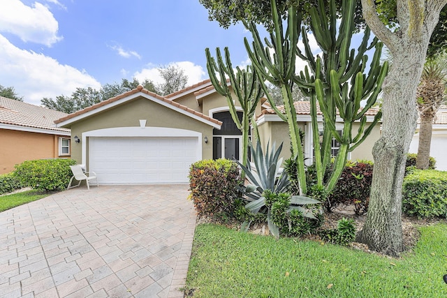 12092 Aprilia Dr, Boynton Beach, FL 33437 - view of front of house featuring stucco siding, an attached garage, decorative driveway, and a tiled roof