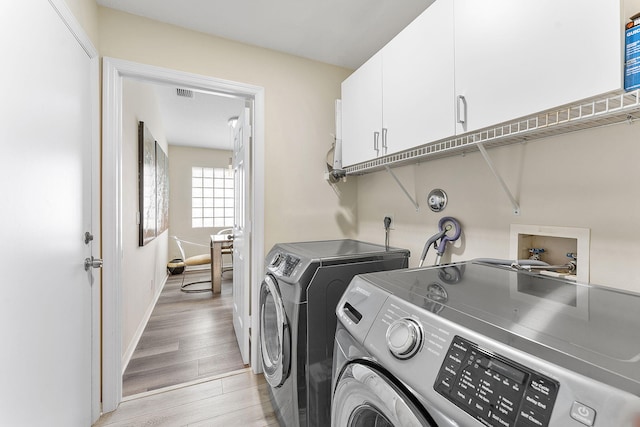 12092 Aprilia Dr, Boynton Beach, FL 33437 - laundry area with washer and dryer, cabinet space, light wood-style floors, and baseboards
