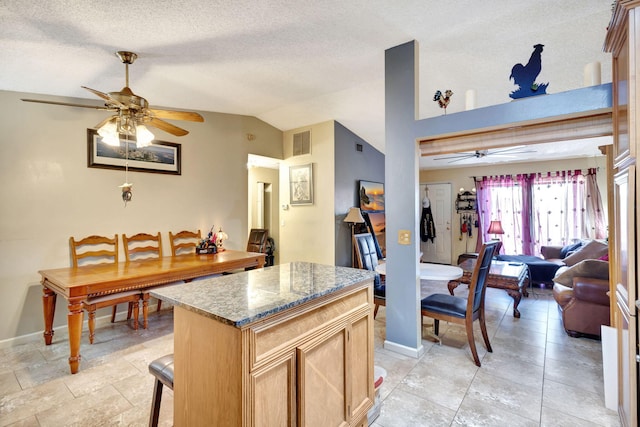 4296 Woodstock Dr Unit A, West Palm Beach, FL 33409 - kitchen with a ceiling fan, lofted ceiling, a kitchen island, baseboards, and open floor plan