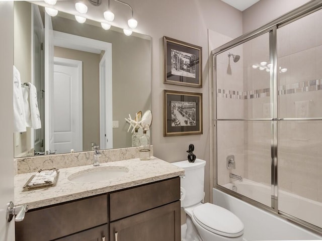 5082 Monroe Cir, Vero Beach, FL 32967 - bathroom with vanity, enclosed tub / shower combo, and toilet