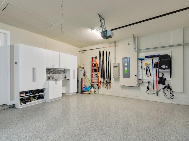 5082 Monroe Cir, Vero Beach, FL 32967 - garage featuring water heater, a garage door opener, electric panel, and a sink