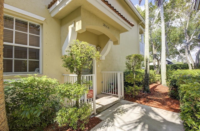 1406 W Wickham Cir Unit A, Delray Beach, FL 33445 - doorway to property featuring stucco siding and a tiled roof