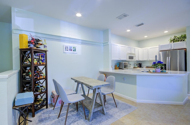 1406 W Wickham Cir Unit A, Delray Beach, FL 33445 - kitchen with stainless steel appliances, white cabinetry, light countertops, a peninsula, and recessed lighting