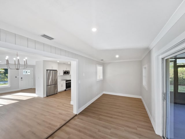 417 Philadelphia Dr, Jupiter, FL 33458 - unfurnished living room featuring ornamental molding, baseboards, a chandelier, recessed lighting, and light wood-style flooring