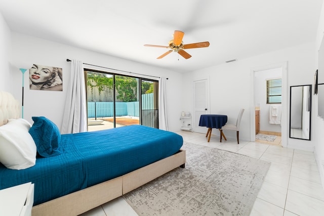 bedroom featuring access to outside, light tile patterned floors, ensuite bath, and ceiling fan