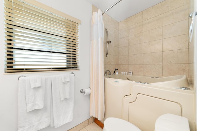 full bathroom with tile patterned floors, toilet, and shower / bath combination with curtain