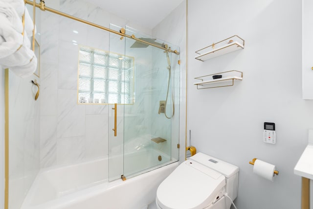 bathroom featuring enclosed tub / shower combo and toilet