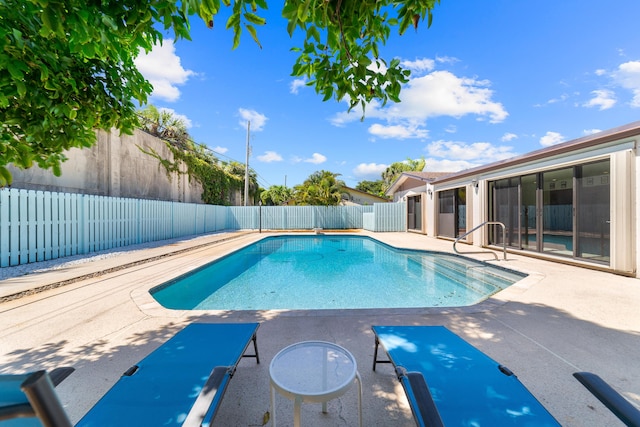 view of pool with a fenced backyard and a patio