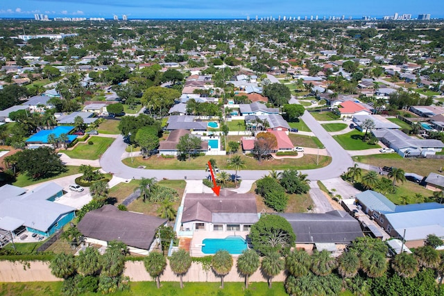 aerial overview of property's location featuring a pool and nearby suburban area
