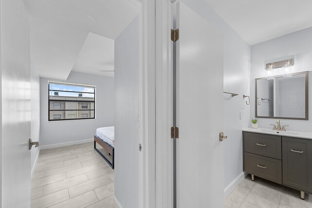 234 Capri E, Delray Beach, FL 33484 - bathroom featuring vanity, baseboards, and tile patterned floors