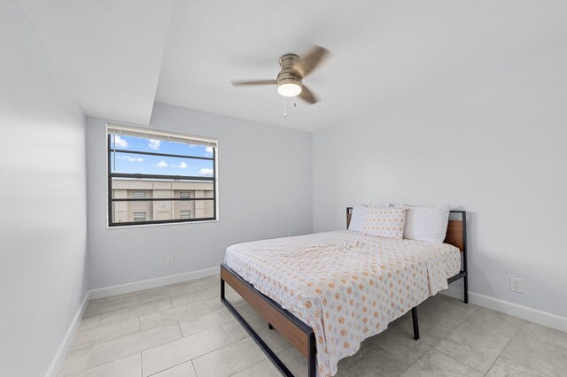 234 Capri E, Delray Beach, FL 33484 - bedroom with baseboards, a ceiling fan, and light tile patterned floors