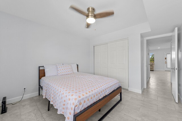 234 Capri E, Delray Beach, FL 33484 - bedroom featuring a closet, baseboards, a ceiling fan, and light tile patterned floors