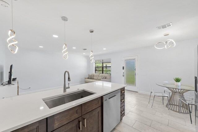 234 Capri E, Delray Beach, FL 33484 - kitchen with stainless steel dishwasher, a sink, dark brown cabinetry, light countertops, and recessed lighting