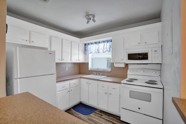3647 SW Natura Ave Unit B, Deerfield Beach, FL 33441 - kitchen featuring white appliances, a sink, white cabinetry, wood finished floors, and backsplash