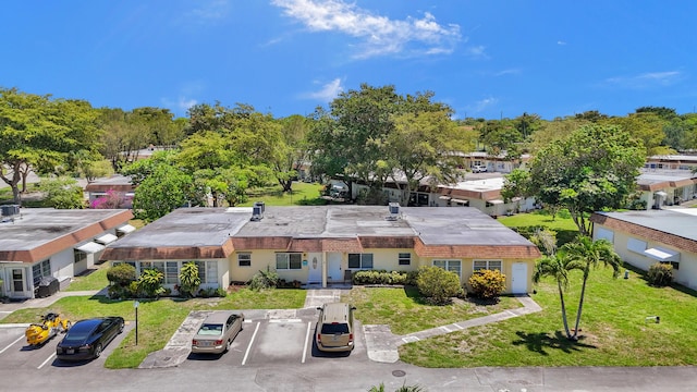 3647 SW Natura Ave Unit B, Deerfield Beach, FL 33441 - view of front of home featuring uncovered parking and a front yard