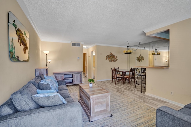3647 SW Natura Ave Unit B, Deerfield Beach, FL 33441 - living area with a textured ceiling, wood finished floors, crown molding, and baseboards
