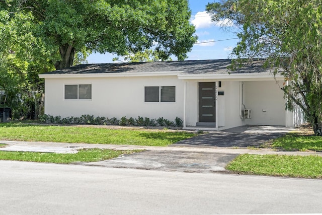 2232 SW 14th Ct, Fort Lauderdale, FL 33312 - view of front of home featuring stucco siding, asphalt driveway, a carport, and a front yard