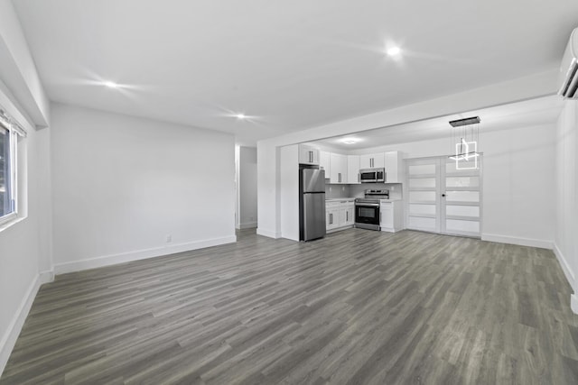 2232 SW 14th Ct, Fort Lauderdale, FL 33312 - unfurnished living room featuring baseboards, dark wood-style flooring, recessed lighting, and a wall unit AC