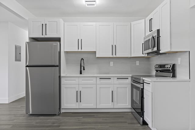2232 SW 14th Ct, Fort Lauderdale, FL 33312 - kitchen with stainless steel appliances, light countertops, decorative backsplash, and white cabinets