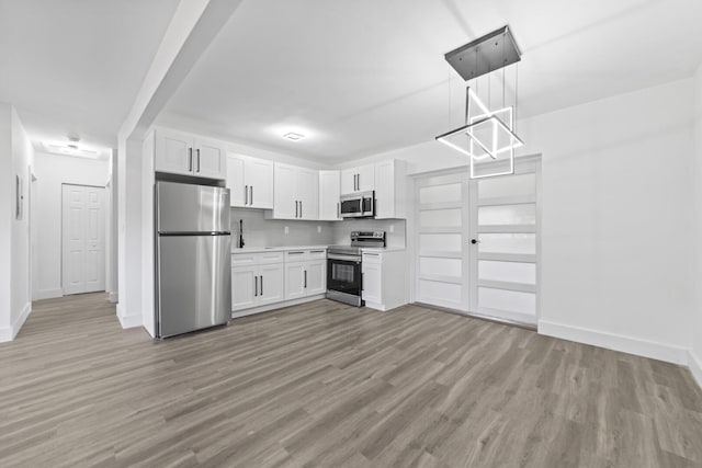 2232 SW 14th Ct, Fort Lauderdale, FL 33312 - kitchen featuring appliances with stainless steel finishes, baseboards, white cabinetry, and light countertops