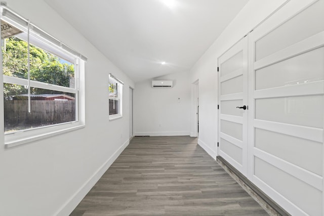 2232 SW 14th Ct, Fort Lauderdale, FL 33312 - hallway with an AC wall unit, vaulted ceiling, baseboards, and wood finished floors