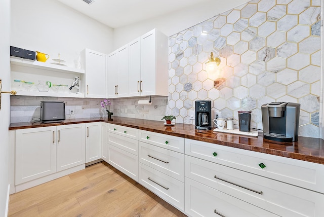 6799 Imperial Woods Rd, Jupiter, FL 33458 - kitchen featuring wooden counters, backsplash, white cabinets, light wood-type flooring, and open shelves