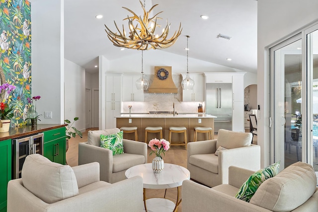 6799 Imperial Woods Rd, Jupiter, FL 33458 - living room featuring lofted ceiling, wine cooler, arched walkways, and recessed lighting