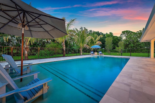 6799 Imperial Woods Rd, Jupiter, FL 33458 - pool at dusk featuring a fenced backyard and a patio