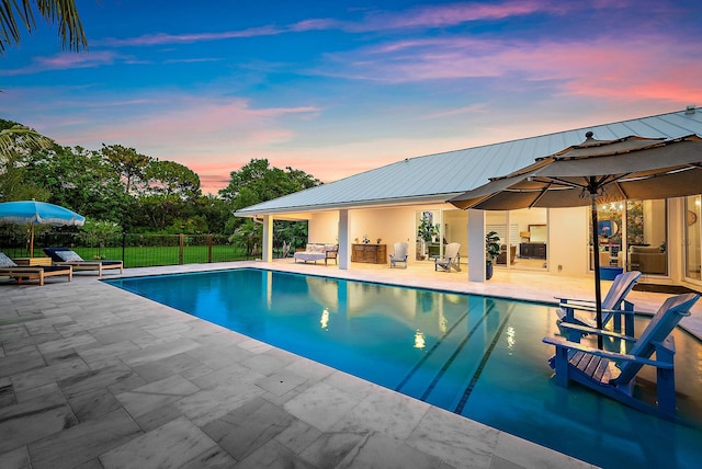 6799 Imperial Woods Rd, Jupiter, FL 33458 - pool at dusk with a patio area