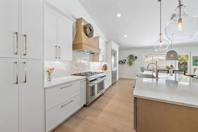 6799 Imperial Woods Rd, Jupiter, FL 33458 - kitchen featuring double oven range, custom range hood, a sink, white cabinets, and recessed lighting