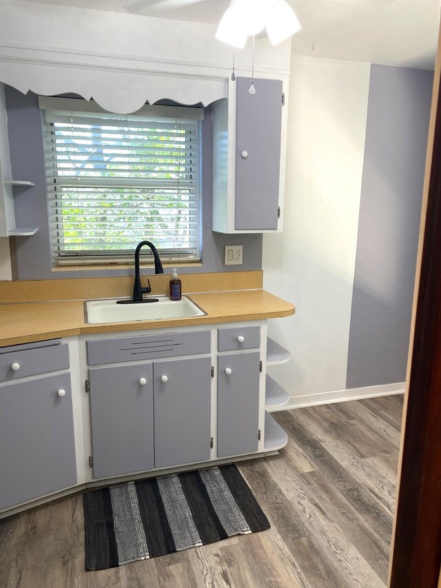 1120 S Federal Hwy, Lake Worth, FL 33460 - kitchen with a sink, dark wood-style flooring, light countertops, open shelves, and a ceiling fan
