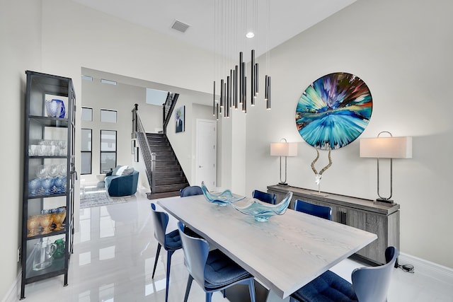 dining room featuring stairs and baseboards