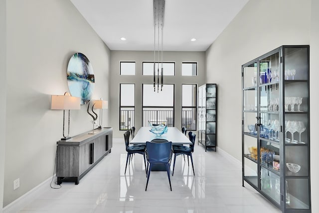 dining room with baseboards and recessed lighting